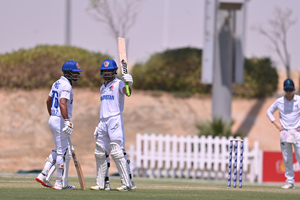 Imran Mir (85) raises his bat after reaching his half-century