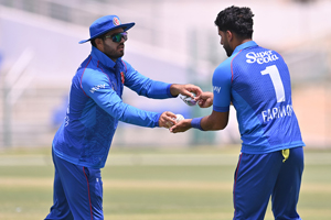 Darwish Rasooli hands over the ball to Farmanullah Safi