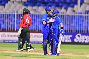 Rahmanullah Gurbaz congratulates Wafiullah Tarakhil as he takes the charge in his Debut T20I game