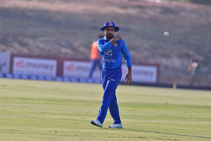 Rashid Khan throws the ball to the bowler